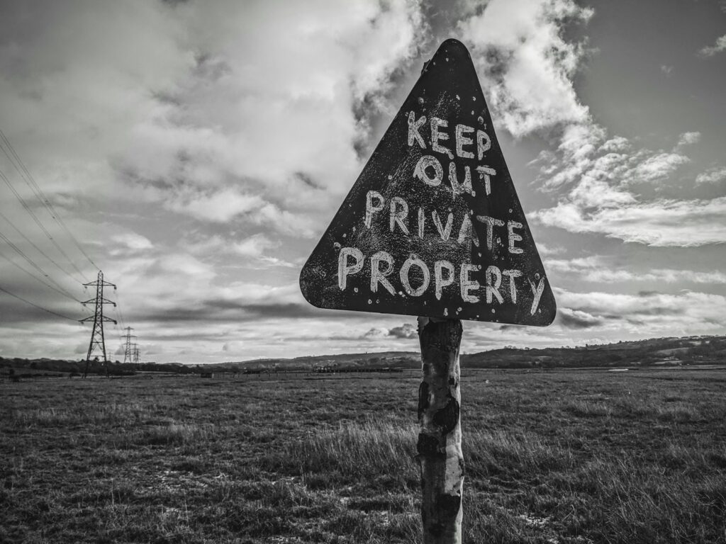 a black and white photo of a sign that says keep out private property