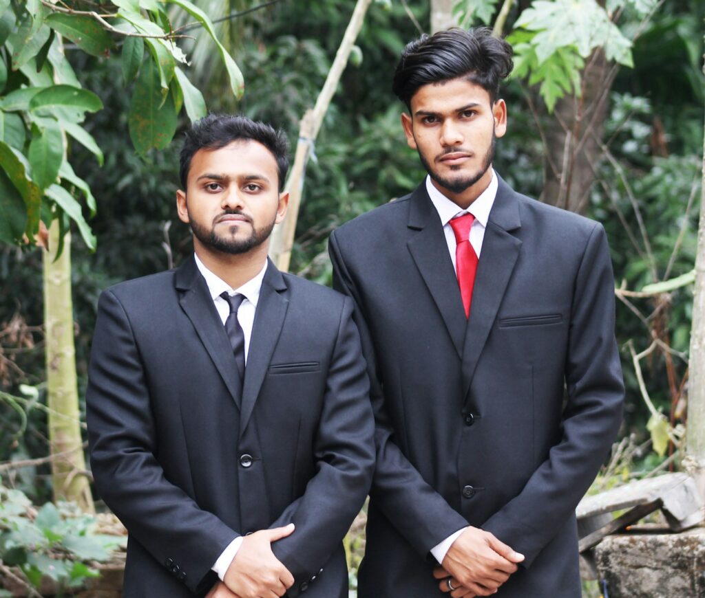 two men in suits standing next to each other